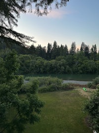 a view of a river and trees at dusk